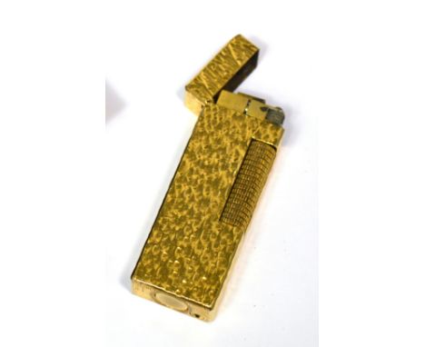 A cased yellow metal Dunhill lighter, sold with instruction booklet and guarantee.