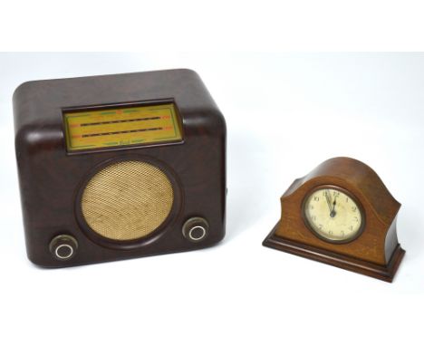 An Edwardian walnut eight day mantel clock, the silvered dial set with Arabic numerals and a vintage Bakelite Bush radio, ser