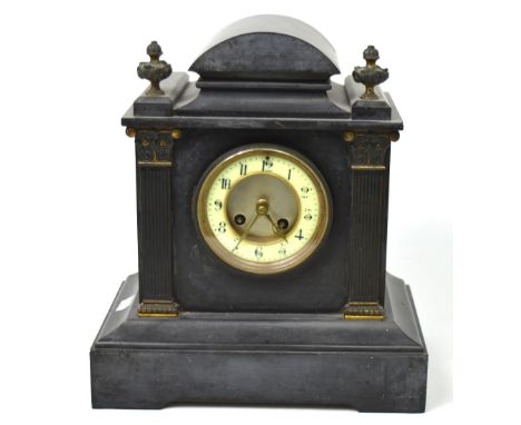 A Victorian black slate mantel clock, the enamel dial set with Arabic numerals and applied brass columns and finials, approx 