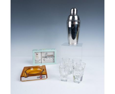 A fun bar collection featuring a sleek cocktail shaker, a vintage orange Martini glass ashtray, six stylish shot glasses, and