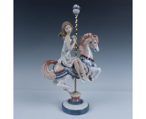 Glossy finish; girl on top of a decorated toy horse. Flower stopper on top of pole. Lladro backstamp. This item has its origi