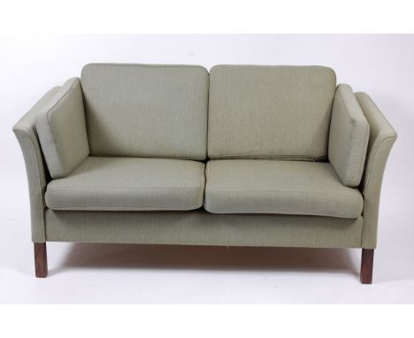 A 1960s Danish teak framed and green upholstered two-seater sofa, raised on square cut supports, w.155cm