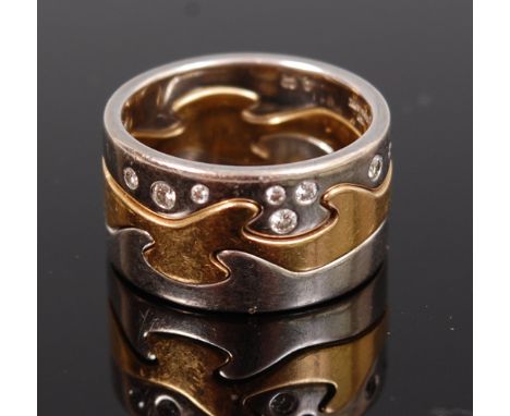 A Georg Jensen yellow and white gold triptych ring, having three interlocking sections, one being diamond set, the centre bei