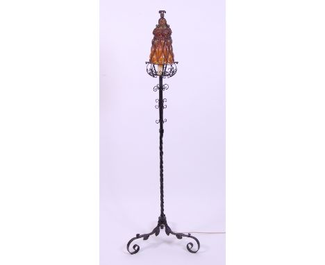 An Arts & Crafts wrought iron standard lamp, having fitted vaseline glass shade with wirework scroll decoration, h.167cm