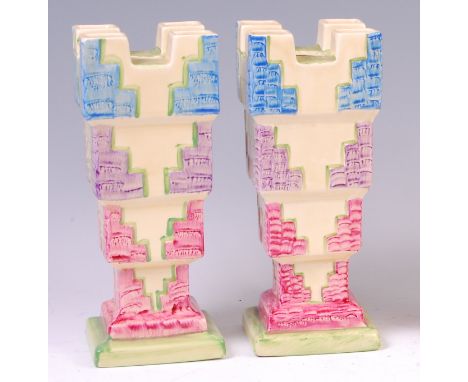 A pair of Myott & Son Art Deco ceramic castle vases, each of square stepped form, with raised and bright colour painted decor