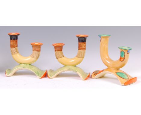 A pair of Myott & Son Art Deco ceramic candelabra, each of U form and on shaped bases, having bright colour banded decoration