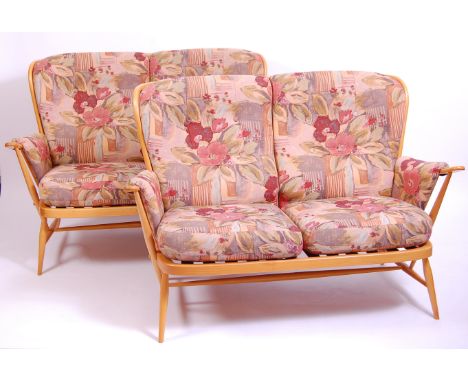 A pair of Ercol blond elm stickback two-seater sofas, each with bright coloured floral upholstered cushions, w.139cm    Condi