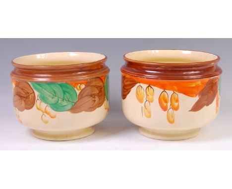 A pair of Myott & Son Art Deco ceramic footed jardinieres, each of circular form, having brown painted rim over stylised flor