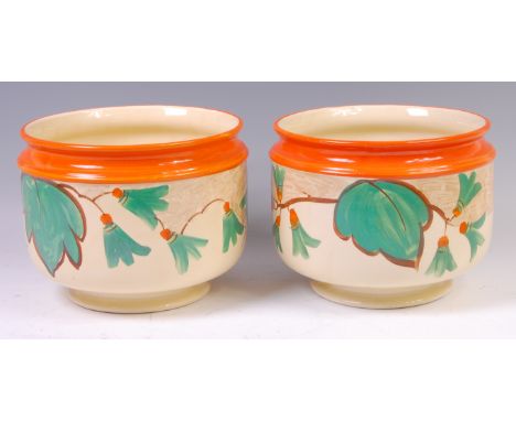 A pair of Myott & Son Art Deco ceramic footed jardinieres, each of circular form, having orange painted rim over stylised flo