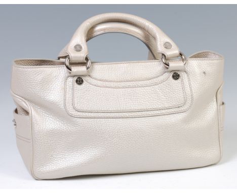 A Celine textured and silvered leather handbag, having silvered metal hardware, twin open compartments, with interior pouches