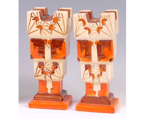 A pair of Myott & Son Art Deco ceramic castle vases, each of square stepped form, with raised and bright colour painted flora