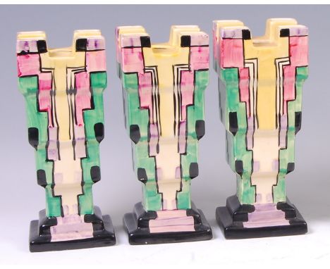 A set of three Myott & Son Art Deco ceramic castle vases, each of square stepped form, with raised block and geometric bright