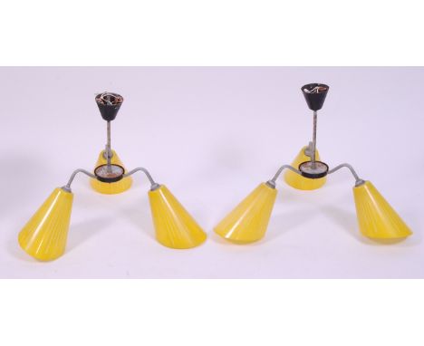 A pair of 1960s three light hanging ceiling pendants, the grey metal shaped arms supporting yellow glass conical shades, drop