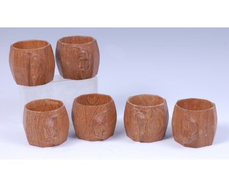 A set of six Robert 'Mouseman' Thompson oak napkin rings, each of curved octagonal faceted form and each with typical carved 