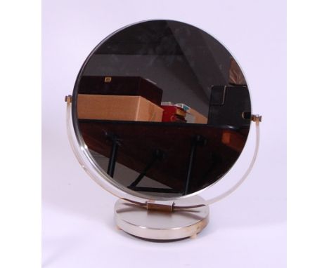 A 1960s brushed steel vanity mirror by Durlston, of circular form, having rotating action, labelled 'Durlston Designs Ltd' ve