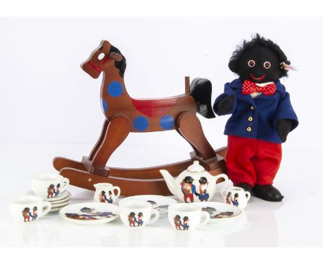 A Steiff Golly Boy, 260 of 2000 from 2001, and a china Golly tea set, and small wooden rocking horse, painted with blue spots