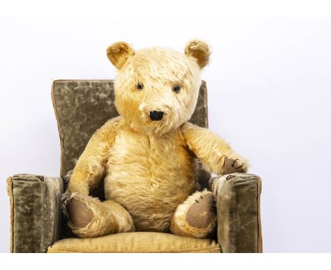 A post-war Chiltern Hugmee teddy bear,  with golden mohair, clear and black glass eyes, black stitched nose, mouth and claws,