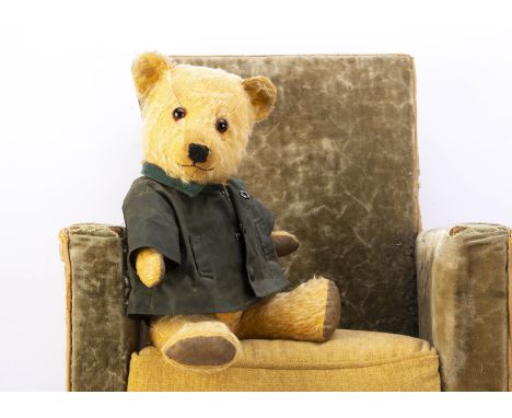 A post-war Chiltern Hugmee teddy bear,  with golden mohair, orange and black glass eyes, black stitched nose and mouth, swive