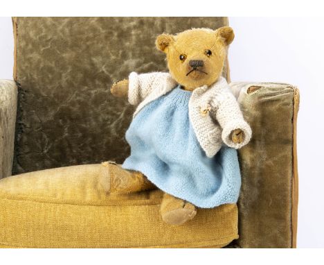 A 1930s Chiltern type teddy bear, with golden mohair, orange and black glass eyes, pronounced muzzle, black stitched nose, mo