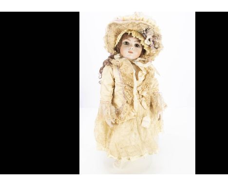 A reproduction Bru bebe by Babs &amp; Stan Tomlinson, with fixed brown glass eyes, brown wig, jointed composition body with b