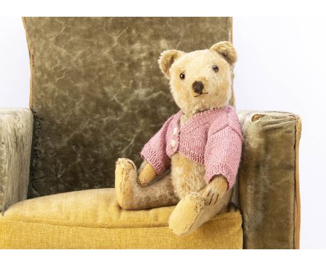 A post-war Steiff teddy bear, with beige mohair, clear and black glass eyes with brown backs, pronounced muzzle, brown stitch