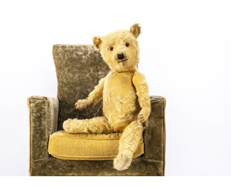 A 1930s Chiltern type teddy bear, with golden mohair, replace orange and black glass eyes, pronounced muzzle, black stitched 