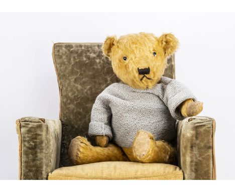 A 1940s British teddy bear,  with light golden mohair, clear and black glass eyes, pronounced muzzle, black stitched nose, mo