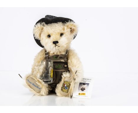 A Steiff Limited Edition musical Deutschlandbär 2001 teddy bear, 525 of 2000,  dressed in suede leader hose, holding a tanker