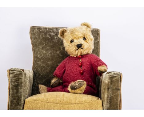 A post-war Chiltern Hugmee teddy bear,  with golden mohair, orange and black glass eyes, black stitched nose and mouth, swive