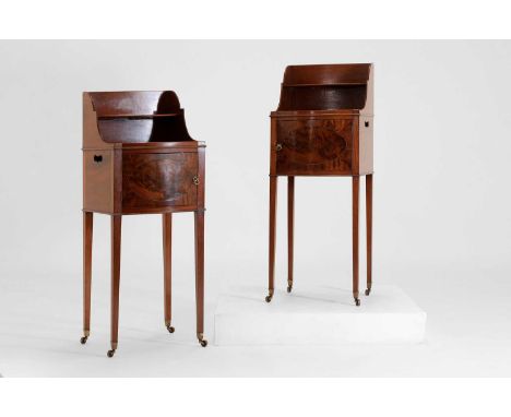 A pair of George III mahogany bedside tables,c.1800, each of bow-fronted outline with a superstructure above a cupboard, rais