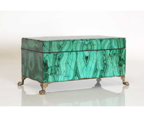 A malachite trinket box,early 20th century, Russian, of rectangular form, raised on four gilt-brass paw feet,25cm wide14cm de