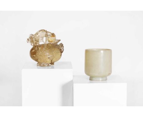 A Chinese smoky quartz carving,late Qing dynasty, of a duck grasping a lotus stem with its beak, 8cm long, anda jade cup,late