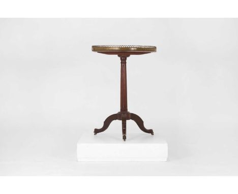 A Directoire mahogany occasional table,late 18th century, French, the white marble top with a brass gallery, raised on a flut