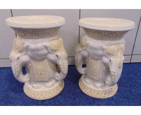 A pair of oriental ceramic garden seats with stylised elephant heads supporting circular tops on raised circular bases, 46cm 
