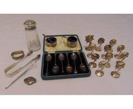 A quantity of hallmarked silver and white metal to include cased teaspoons, a pair of tongs, a glass sugar sifter with silver