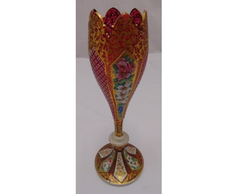 A Bohemian overlaid ruby vase decorated with panels of flowers and leaves on raised circular base, 35.5cm (h)