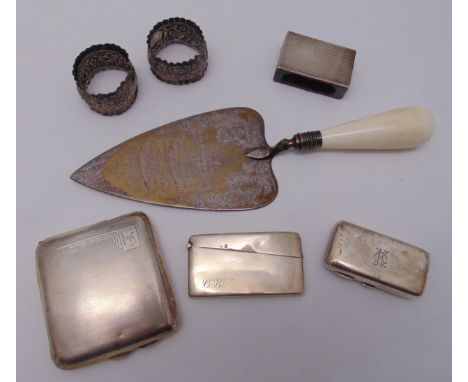 A quantity of hallmarked silver to include a presentation trowel, a cigarette case, a snuff box, a card case, a match box hol