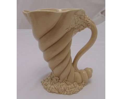 A Clarice Cliff Cornucopia jug with scroll handle on shell and mollusc base, marks to the base, 25cm (h)