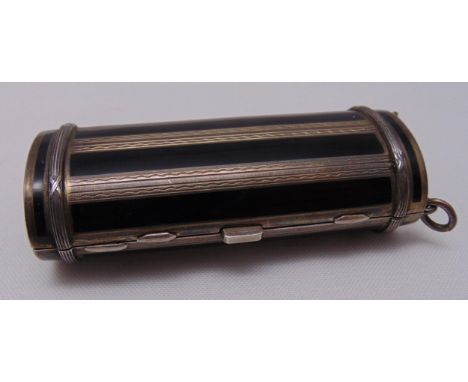 A continental white metal and enamel compact of compressed cylindrical form hinged to reveal a mirror and three compartments,
