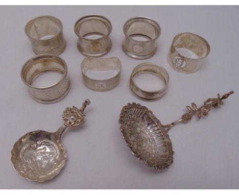 A quantity of silver and white metal to include seven napkin rings and two caddy spoons, approx total weight 188g