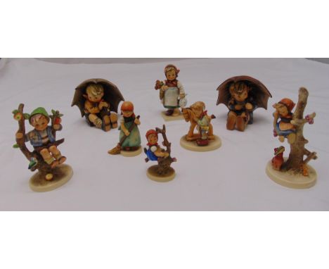 Eight Goebel figurines of children in various pursuits on raised oval bases, marks to the bases