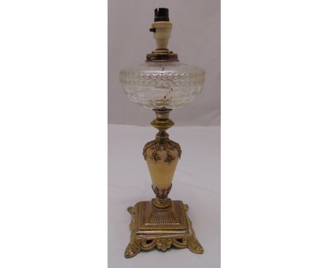 A Victorian oil lamp base with glass reservoir on raised square base, stylised leaf feet, converted to electric, 47cm (h)