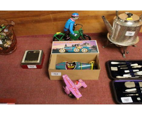A boxed clockwork tinplate model of a Bugatti T35 racer, a tinplate model of a motorcycle and another of  a training plane