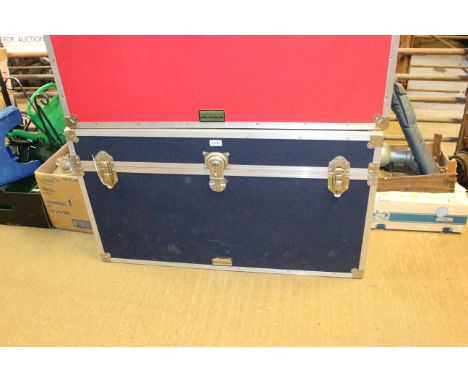 A blue canvas and metal bound storage trunk