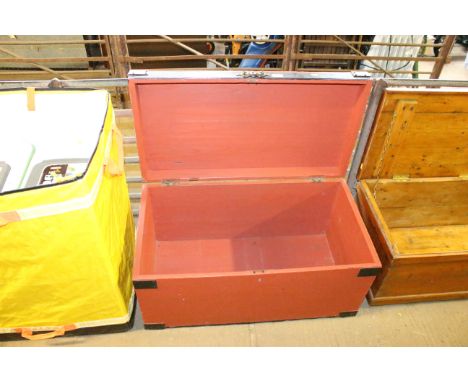 A red painted wooden storage trunk