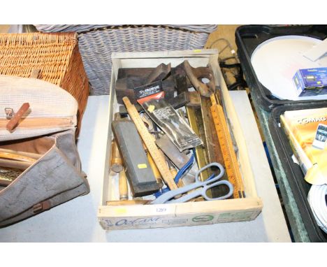 A tray containing various hand tools to include wooden measures, sharpening stone, shears, files, hand saws, wooden planes et