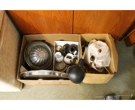 Two boxes containing various metalware; various moulds; cutlery etc and a clip on adjustable lamp
