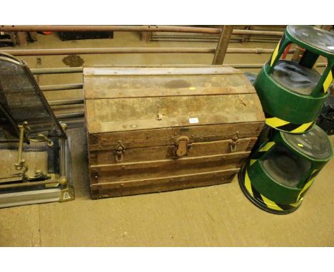 A wooden and metal bound canvas travelling trunk with dome topped lid 