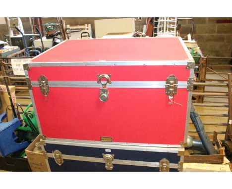 A red canvas and metal bound storage trunk