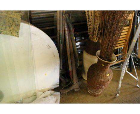A quantity of long handled tools to include hoes, rakes, garden fork etc.